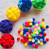 Soft sensory pom poms designed for kids' tactile exploration and hands-on sensory play.